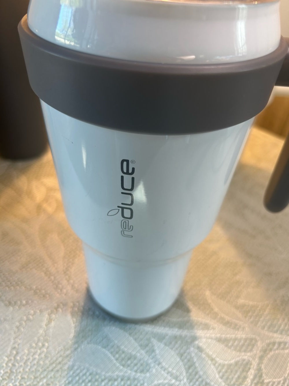 Reduce White Travel Mug with Gray Grip